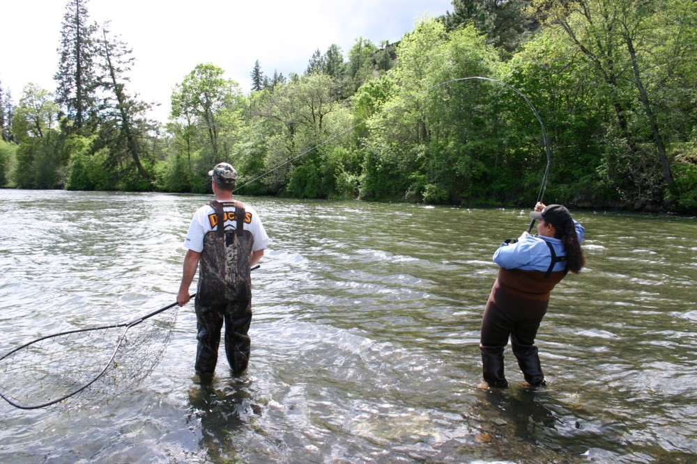 Spring salmon fishing on the Rogue River near Shady Cove. Nancy Peck fights a spring salmon. Rogue River spring salmon fishing. Rogue River fishing guides. Fishing guides Rogue River.